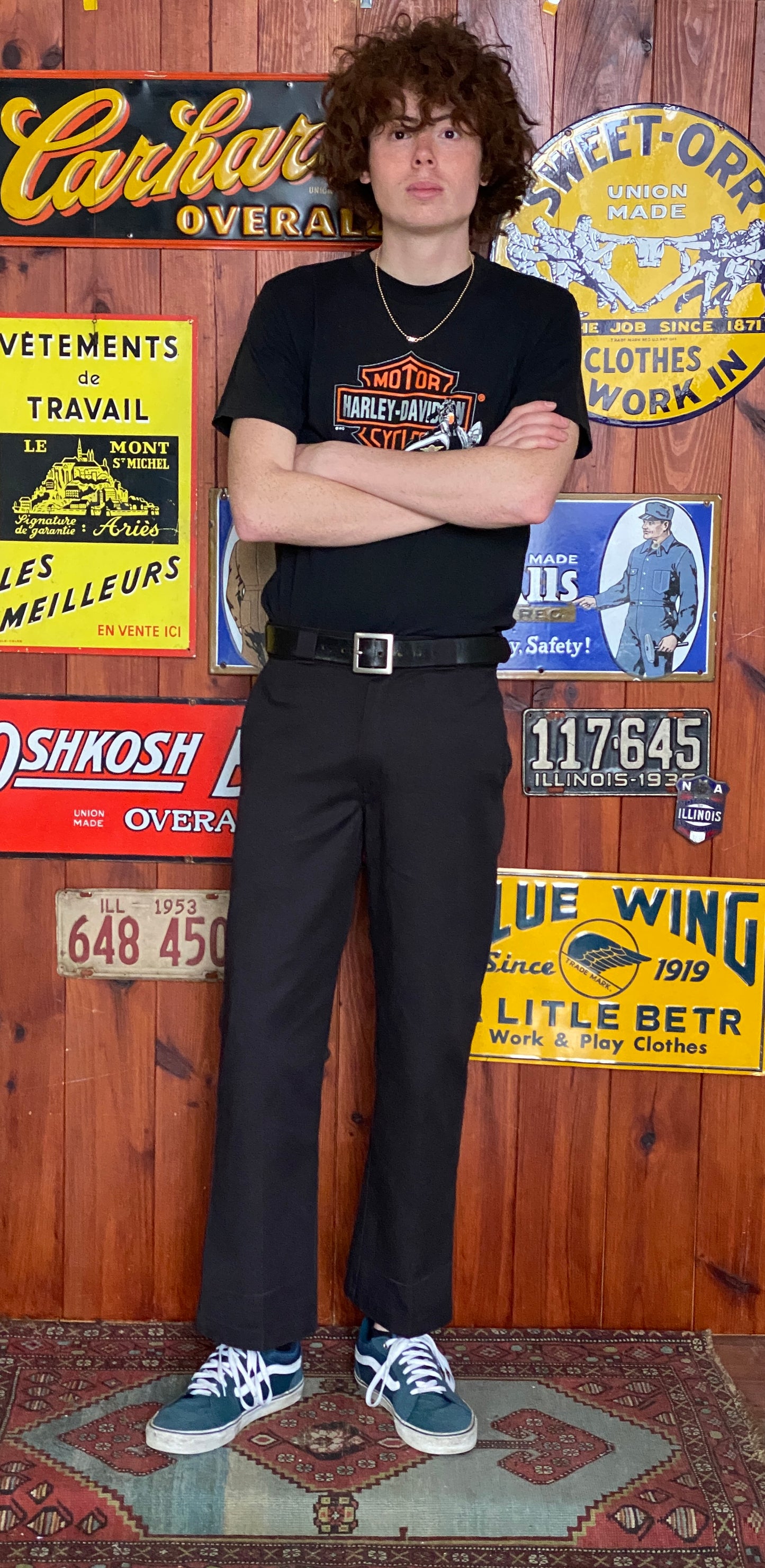 Person wearing black work pants with a visible dickies brand logo.