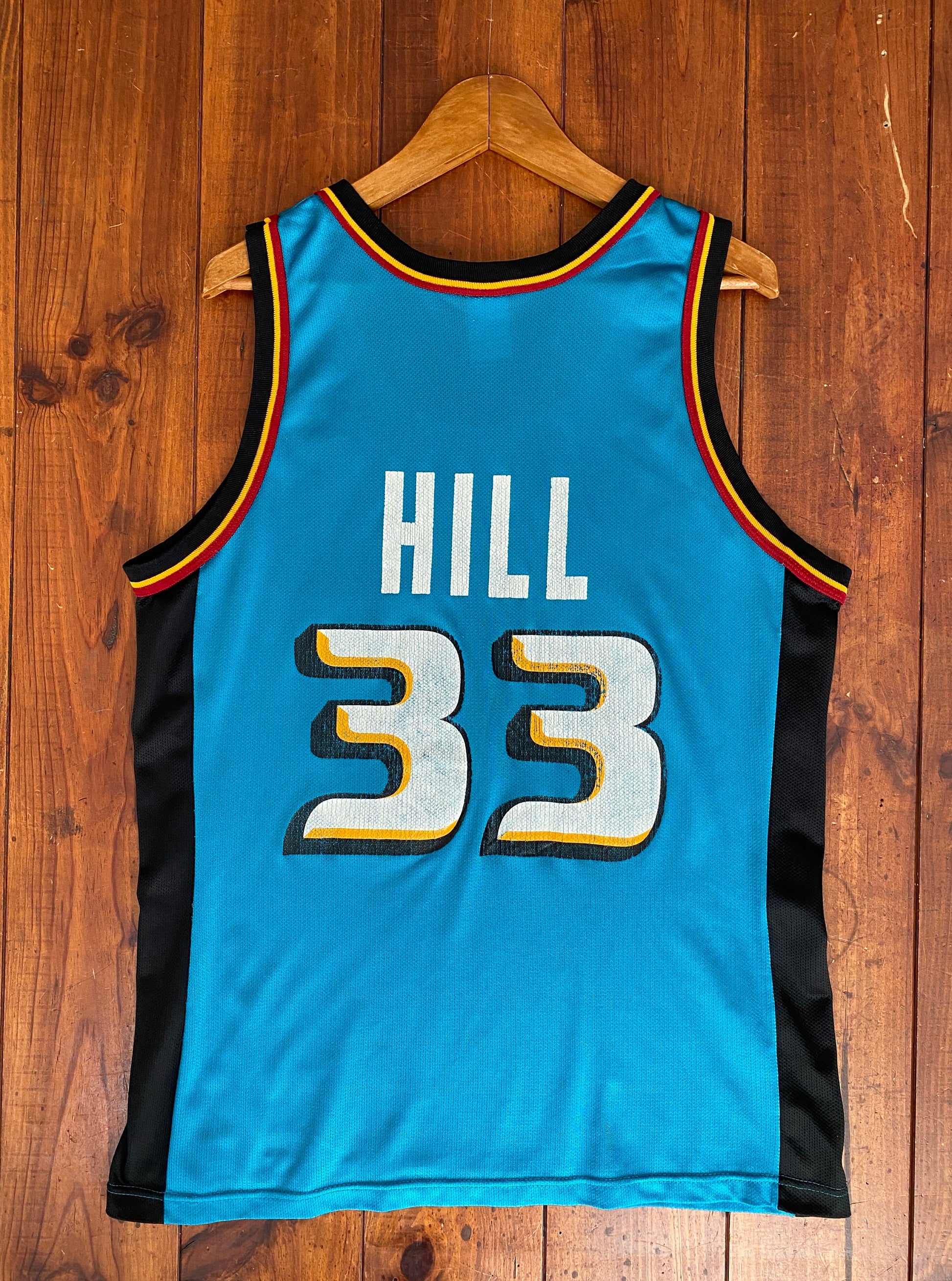 Vintage 90s NBA Champion Detroit Pistons Hill #33 jersey, size 44 - back view. Made in USA by Champion.