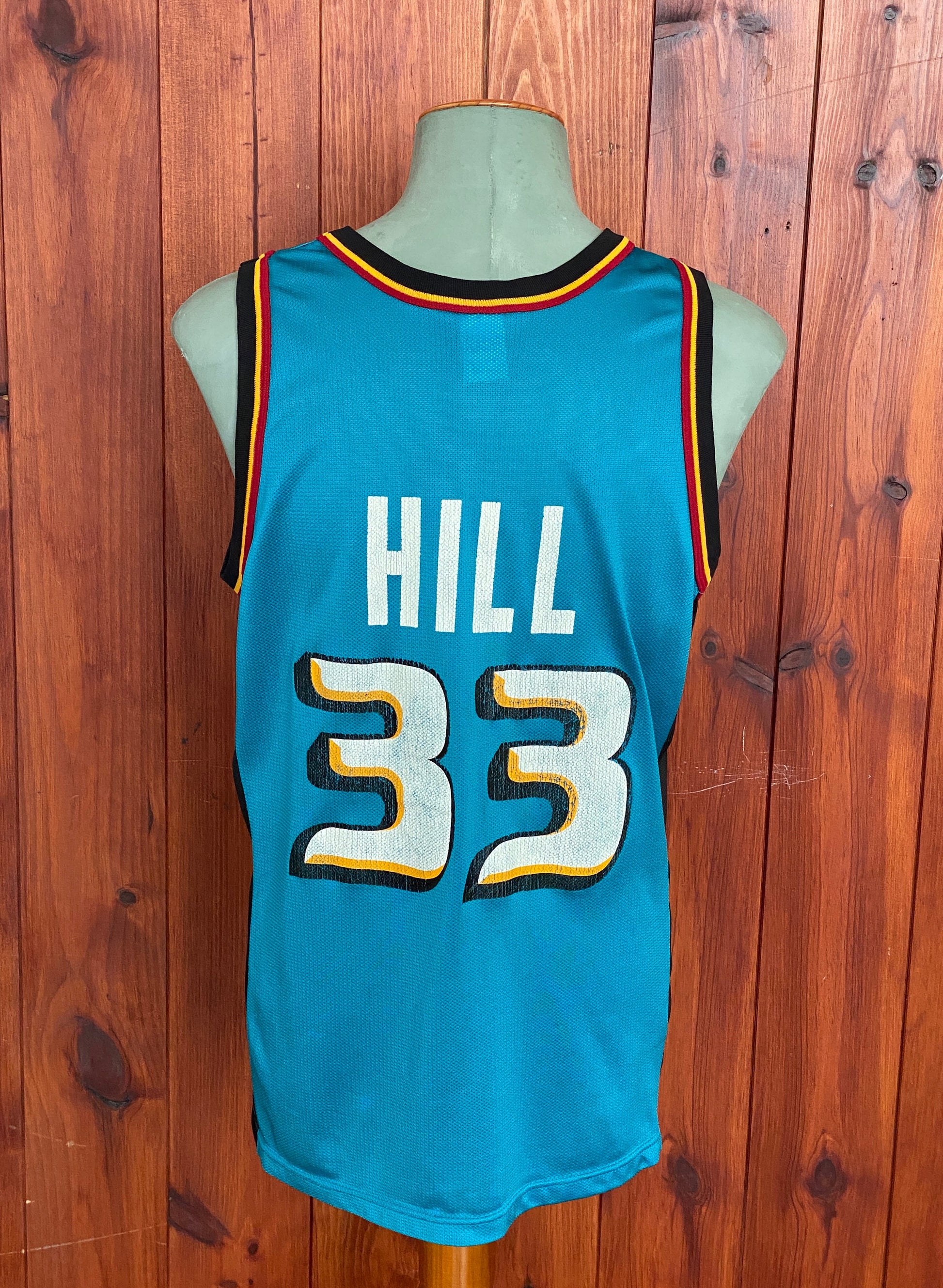 Vintage 90s NBA Champion Detroit Pistons Hill #33 jersey, size 44 - back view. Made in USA by Champion.
