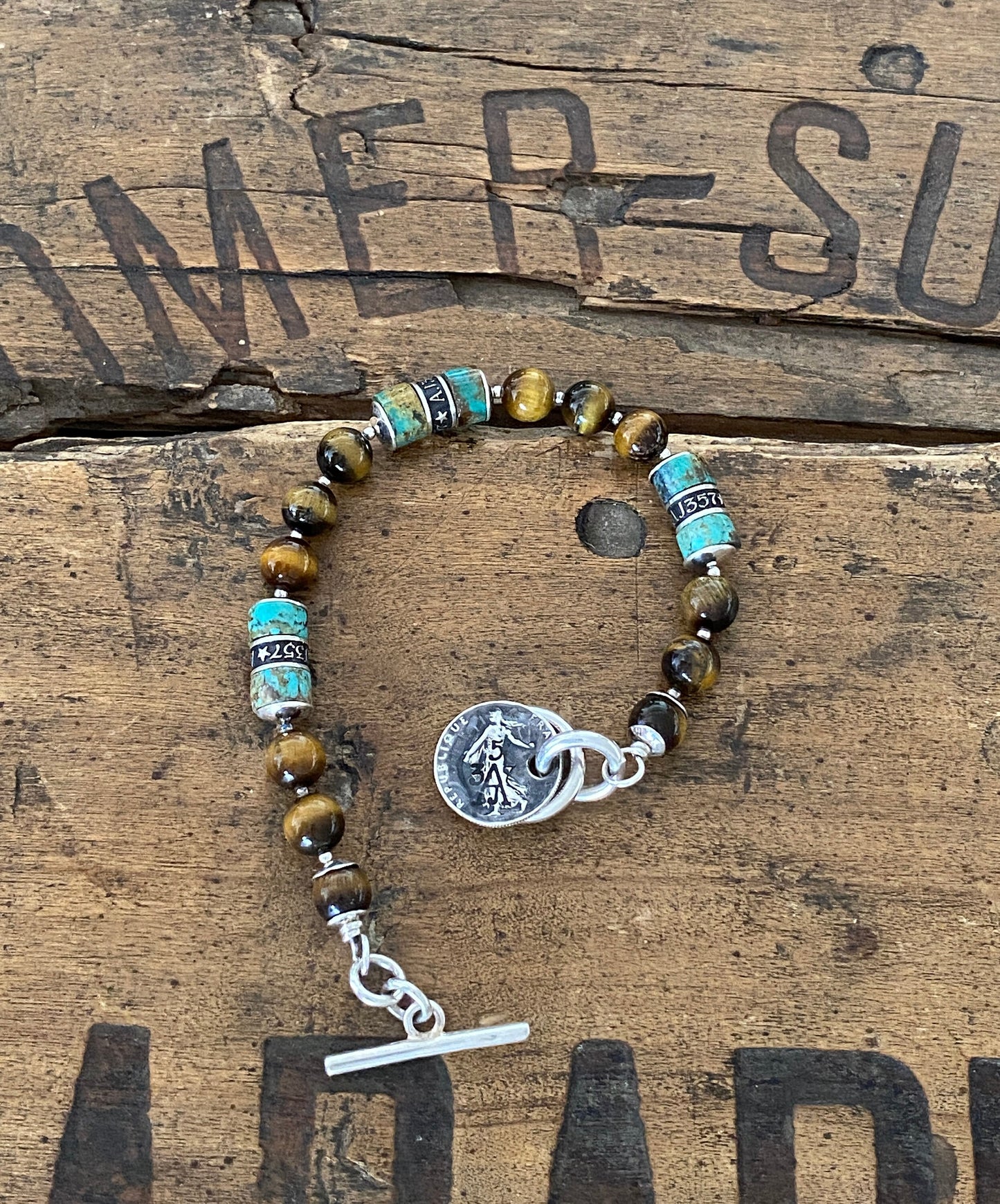 The Pacific Bracelet is made of, Turquoise, sterling silver, Vintage coin and Tiger eye 8mm Beads.
