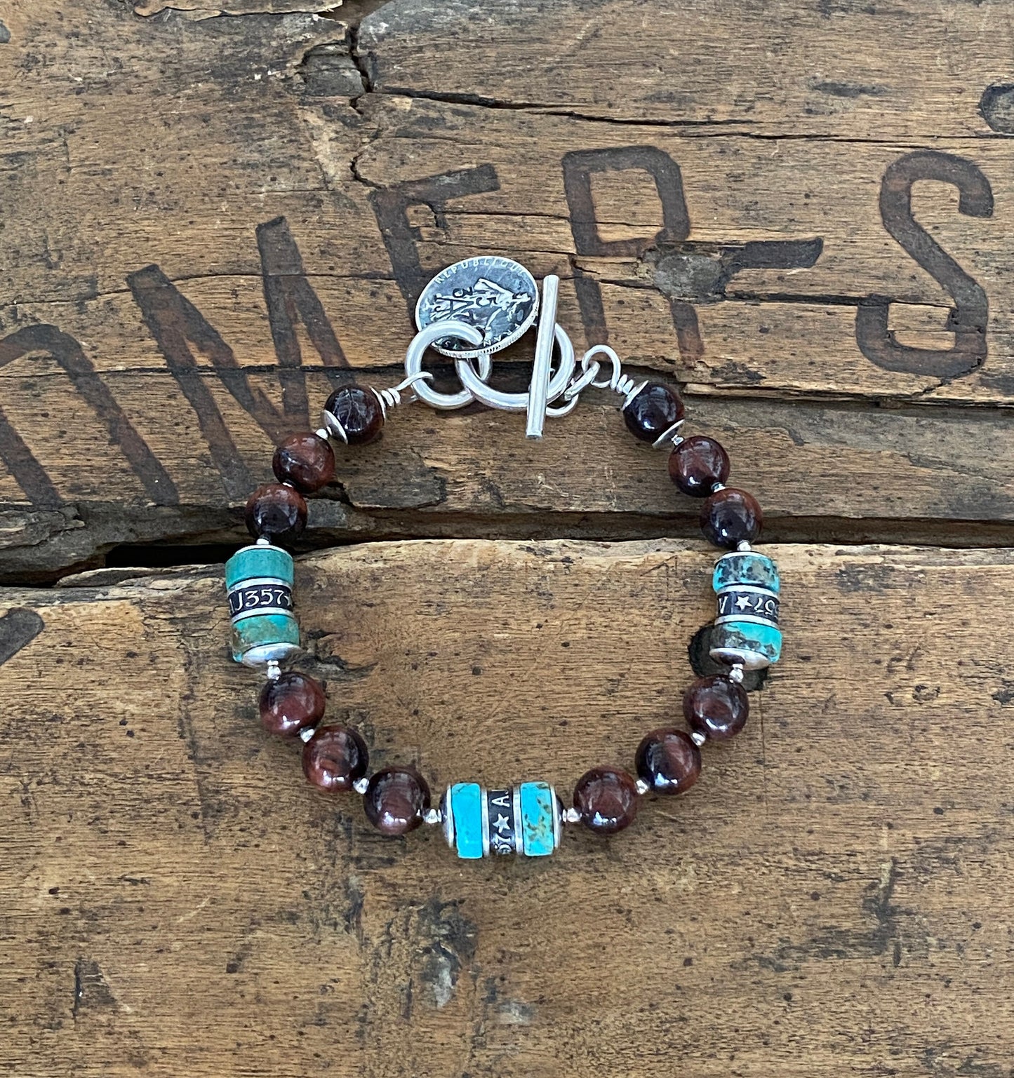 The Pacific Bracelet is made of, Turquoise, sterling silver, Vintage silver coin and Red Tiger eye 8mm Beads.
