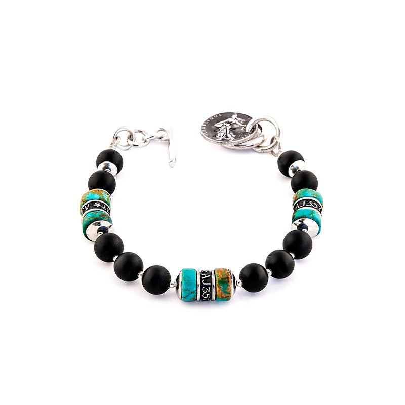 The Pacific Bracelet is made of, Turquoise, sterling silver, Vintage silver coin and Obsidian 8mm Beads.
