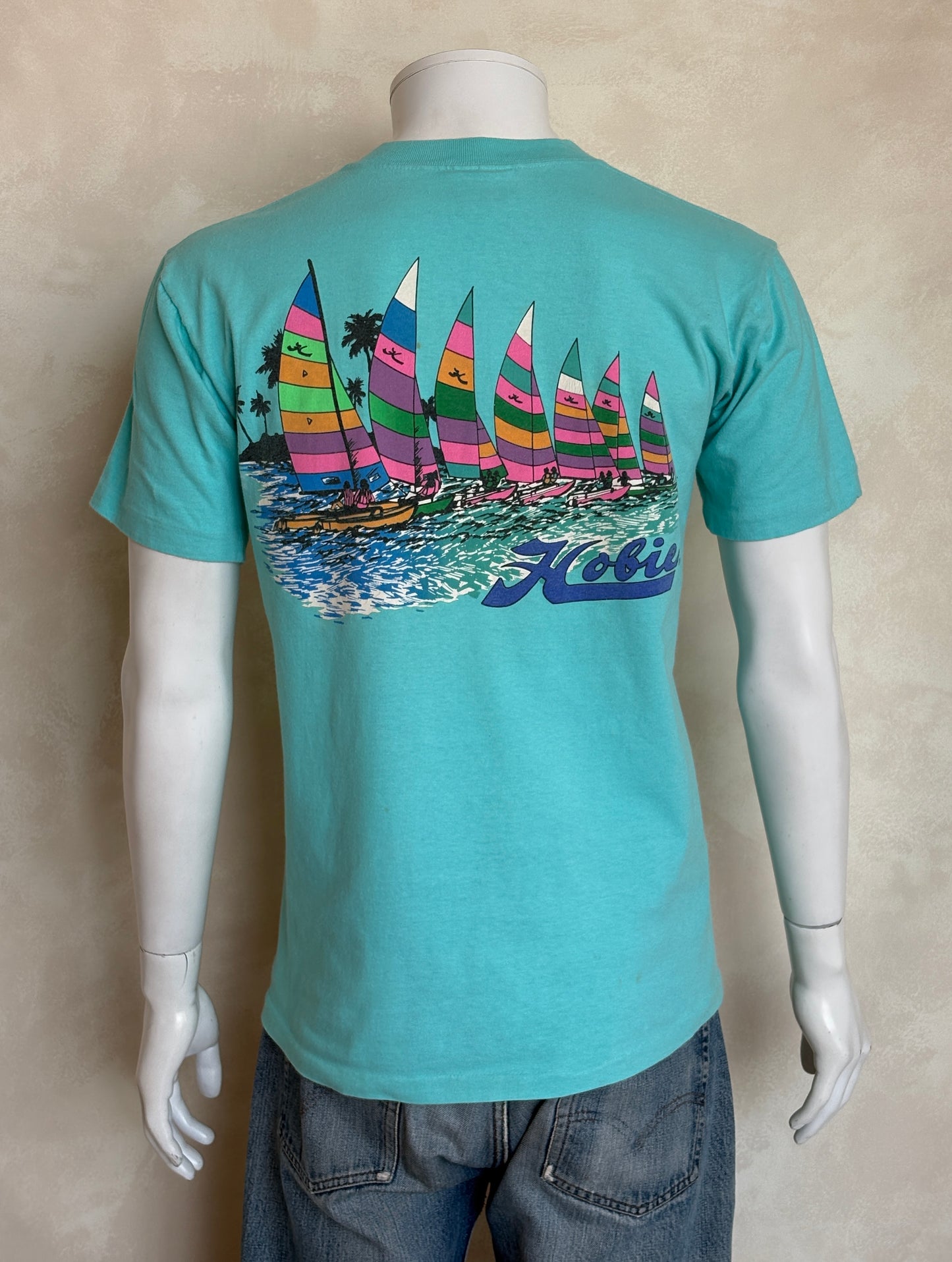 Vintage Hobie Cat sailing tee – vibrant 80s beach scene with colorful catamarans. Large
