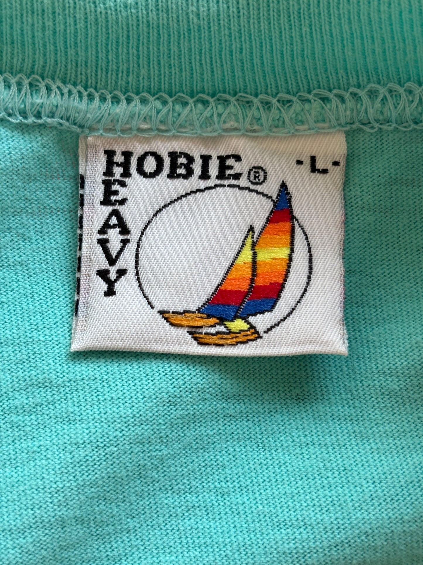 Vintage Hobie Cat sailing tee – vibrant 80s beach scene with colorful catamarans. Large