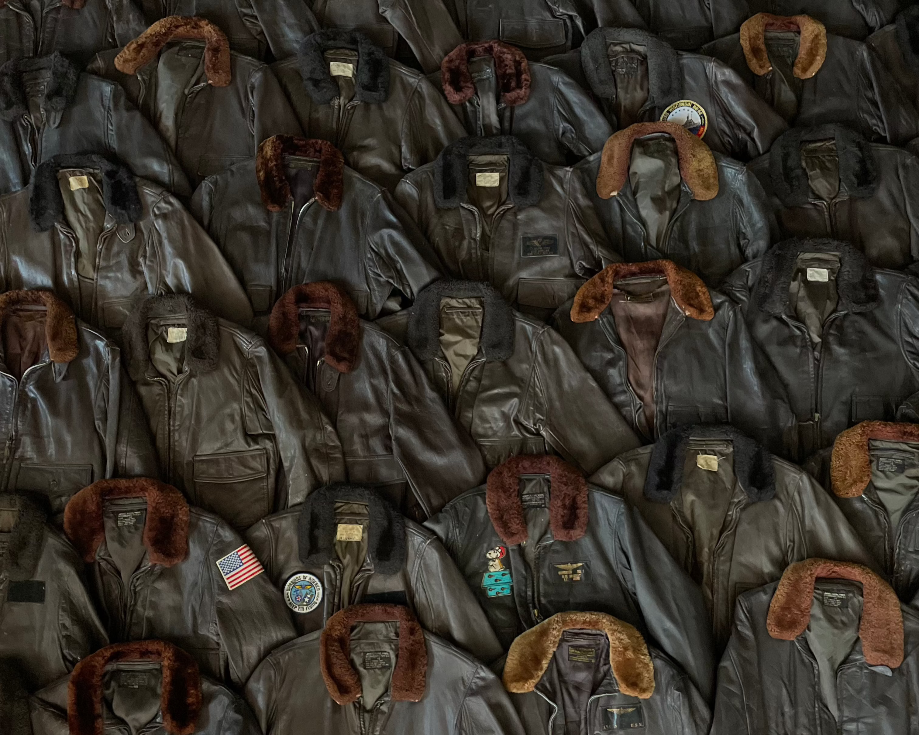 Collection of authentic vintage American leather flight jackets with shearling collars and military patches — curated by USA Vintage BCN in Barcelona