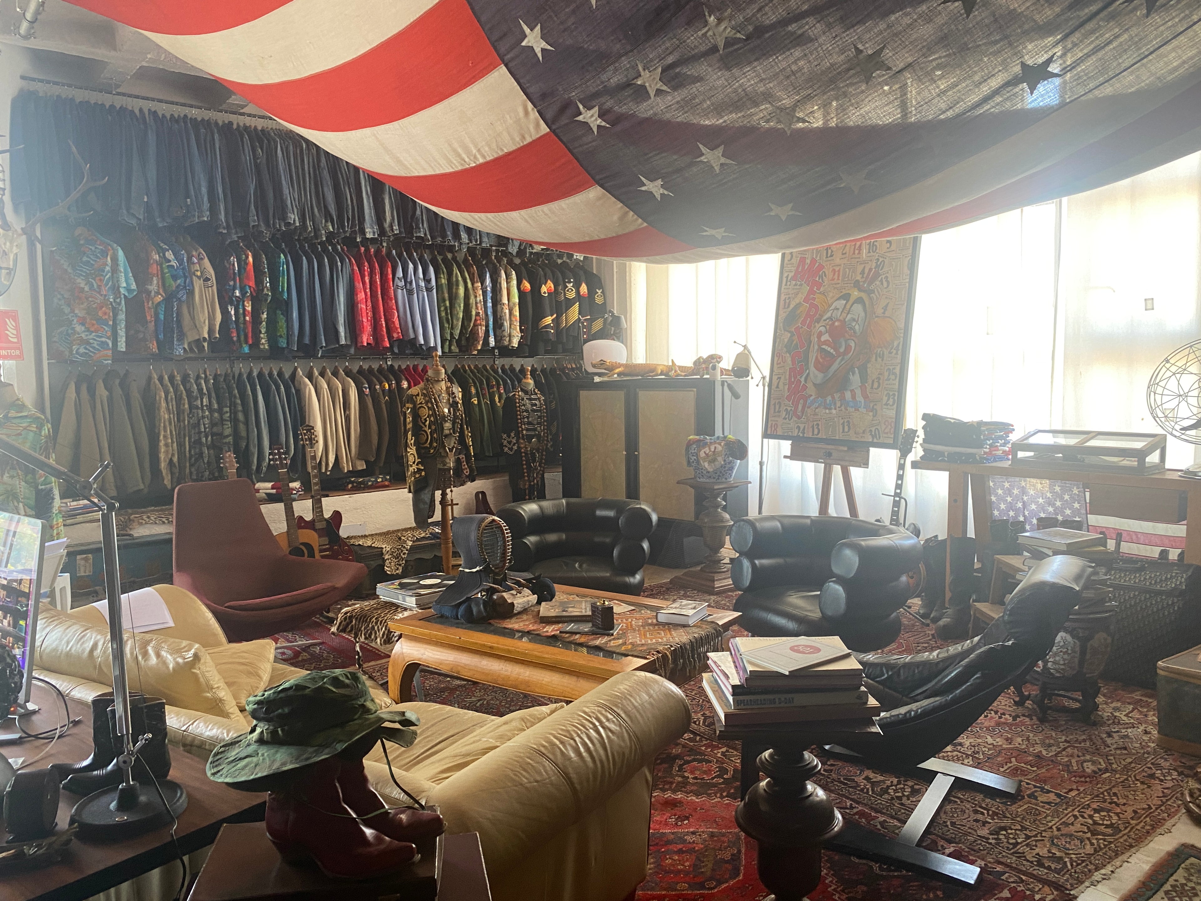 Authentic vintage clothing store in Barcelona featuring American flag decor, curated denim and military jackets, and mid-century furniture — USA Vintage BCN showroom